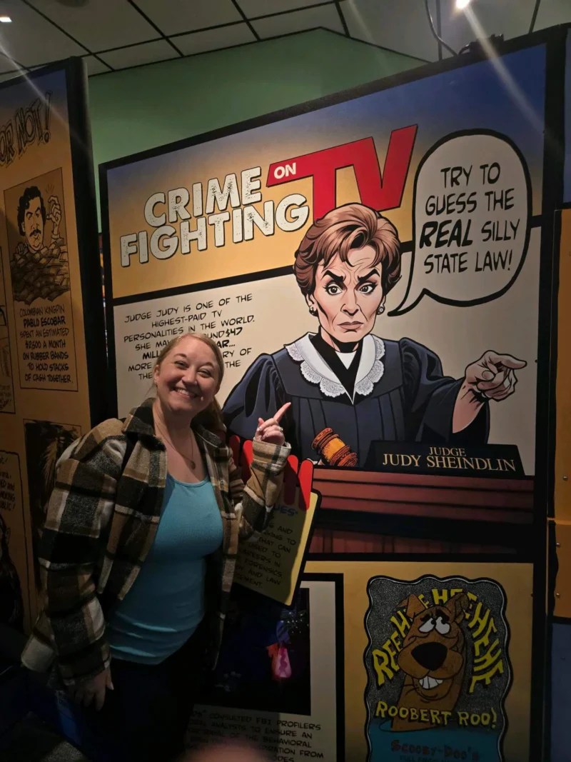 Yon dam souri epi li montre yon desen miray ki gen yon jij sevè.